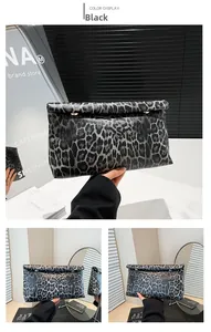 Detail of grey leopard print clutch bag with metallic studs and fold-over closure design