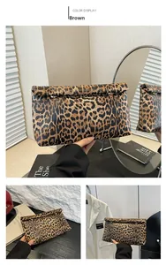Detail view of stylish leopard print clutch bag with metallic rings and magnetic closure