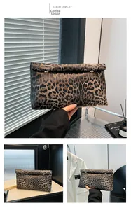 Detail of leopard print clutch bag featuring rolled edge and metal snap button closure
