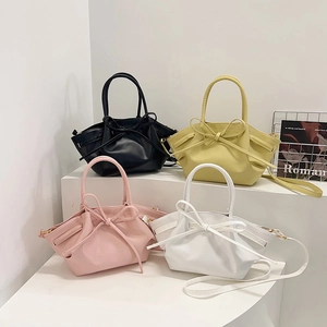 Fashionable women's bow tie bucket bag in four colors with crossbody strap and handle