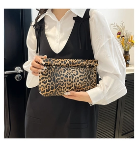Detail of leopard print clutch bag with rolled top closure and chic metal hook buckle