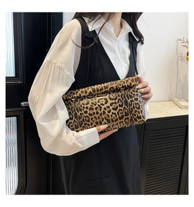 Detail shot of leopard print crossbody bag with metallic hardware and textured faux leather
