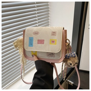 Pink and beige crossbody bag featuring marble texture lid and cute character charms