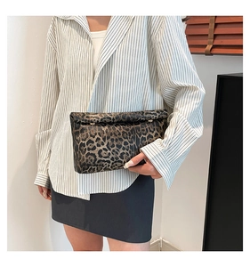 Detail of classic leopard print envelope clutch with metal buckle and premium texture