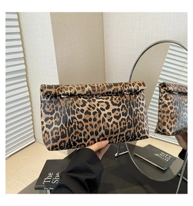 Detail of leopard print PU leather clutch with metal buckle and fold-over flap design