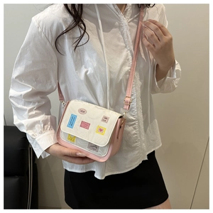 Detailed view of pink and white crossbody bag featuring cute love stickers and heart patterns