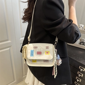 White minimalist crossbody square bag with colorful stickers and plush charm