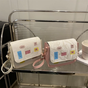 Chic patchwork tote bag with marble pattern flap and heart stickers on clear shelf