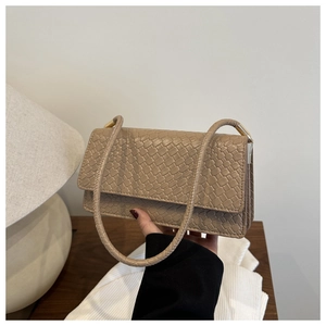 Detail shot of light brown snake print texture on minimalist PU leather shoulder bag