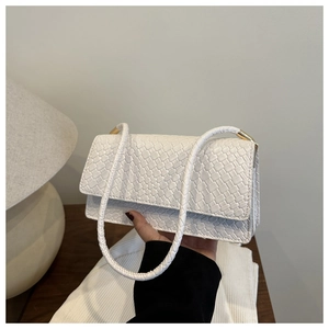 Close-up of white woven leather handbag texture with elegant gold metal hardware details