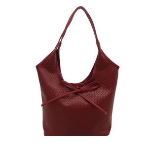 Deep red woven leather tote bag with a decorative bow knot and wide shoulder strap