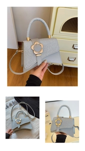 Détail du sac bandoulière gris avec boucle fleur dorée et texture argentée brillante
