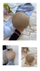 Close-up of beige woven spherical clutch bag with golden chain strap for summer