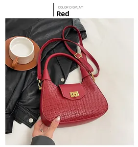 Detail of red woven dumpling bag with gold metal clasp on a lifestyle background