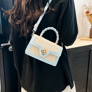 Straw and light blue leather crossbody bag with flower buckle and twisted handle