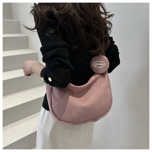 Detail of pink nylon crossbody tote with textured waffle fabric and small coin purse