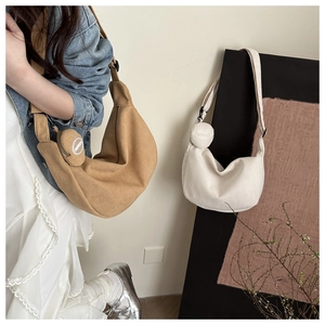 Detail view of corduroy crescent crossbody bag set with matching round coin pouch