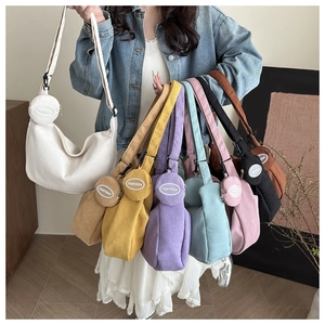 Detail of corduroy hobo tote bags in various colors with matching round coin purses
