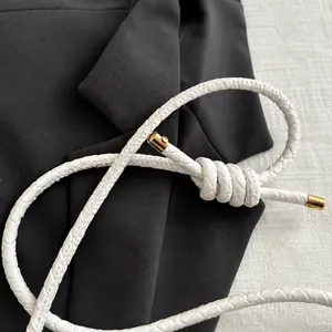 Detalle de la correa trenzada blanca para bolso con puntas de metal dorado fino