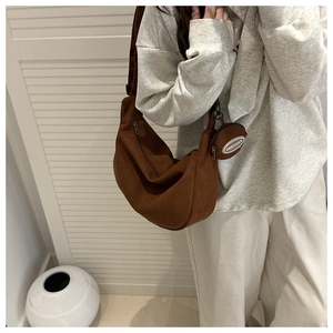 Detail of brown corduroy crescent bag with matching small round coin purse charm