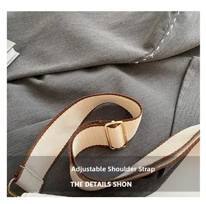 Detail of adjustable woven shoulder strap with gold buckle for crossbody saddle bag