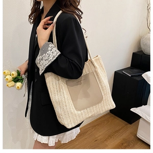 Close-up of beige woven tote bag with faux leather pocket and cotton rope handles