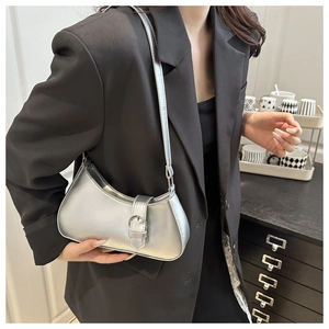 Details der silbernen Halbmondtasche mit Metallschnalle kombiniert mit schwarzem Blazer