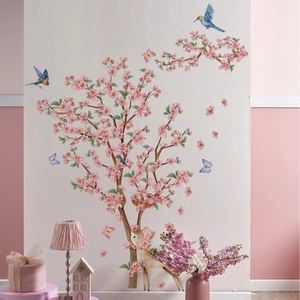 Detail of pink flower tree wall decals with blue birds and deer in a cozy home setting