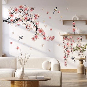 Detailed view of pink cherry blossoms and birds wall stickers in a modern living room