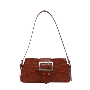 Retro brown crocodile embossed patent leather tote bag with silver buckle on white background
