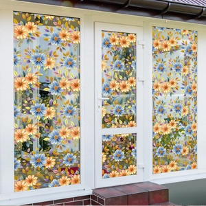 Detail of floral window film featuring orange and blue flowers for privacy and decor