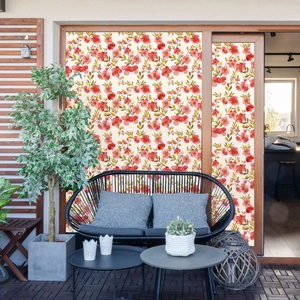Detail of red floral static window film showing dense flower patterns on a patio glass door