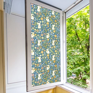 Floral rabbit window film detail with translucent privacy patterns on a blue background