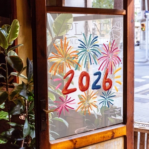 Close-up of 2026 colorful fireworks window sticker on glass door for New Year decor