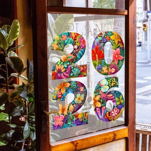 Detailed view of colorful 2026 floral static window clings on glass with butterfly patterns