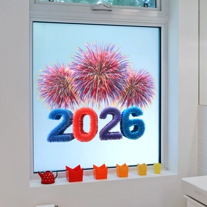 Detail of 2026 New Year static window clings with colorful fireworks on a glass surface