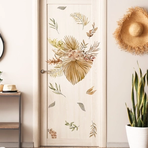 Detail of boho style wall stickers with palm leaves and dried flowers in earthy tones