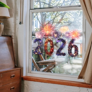 Detailed view of colorful 2026 firework static window clings on home glass decor