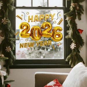 Macro view of metallic gold 3D HAPPY 2026 NEW YEAR stickers on window glass
