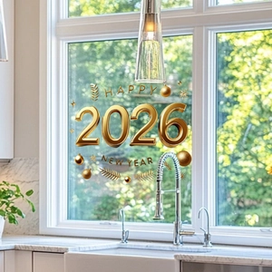 Close-up of golden 3D Happy 2026 New Year static window sticker with festive pine motifs