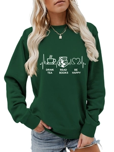 Detail of white graphic print on dark green sweatshirt featuring tea, books, and heart