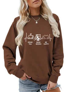 Detail of white slogan print on deep brown sweatshirt showing tea and book graphics