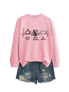 Detail view of pink sweatshirt with drink tea read books be happy graphic and denim shorts