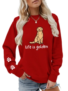 Detail of red crewneck sweatshirt featuring white paw prints with hearts on the sleeve