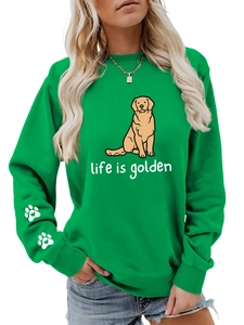 Detail of green crewneck sweatshirt featuring golden retriever print and life is golden text
