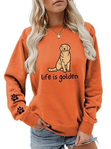 Detail of cute paw print with heart on the right sleeve of this orange graphic sweatshirt