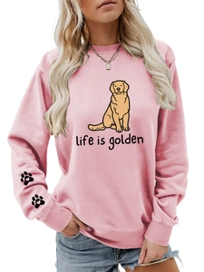 Detail of pink crewneck sweatshirt with golden retriever print and heart paw on sleeve