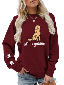 Detail of burgundy sweatshirt featuring a golden retriever and heart paw prints on the sleeve