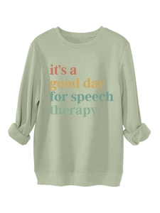 Detalle de sudadera verde claro con colorido estampado it's a good day for speech therapy