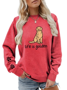 Close-up of Life is Golden print and dog paw details on red crewneck sweatshirt